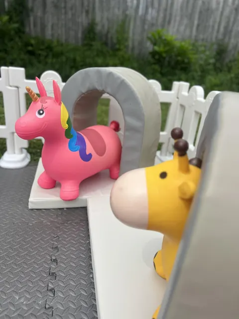 Deluxe soft play setup with a unicorn and giraffe ride-on toy