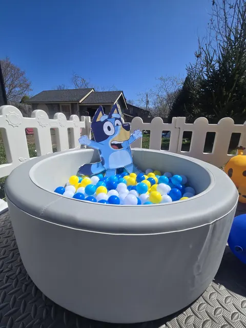 Character themed ball pit with blue, yellow and white balls