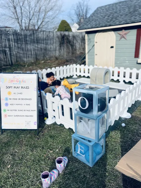 Soft play setup with stacked letter blocks and a rules sign