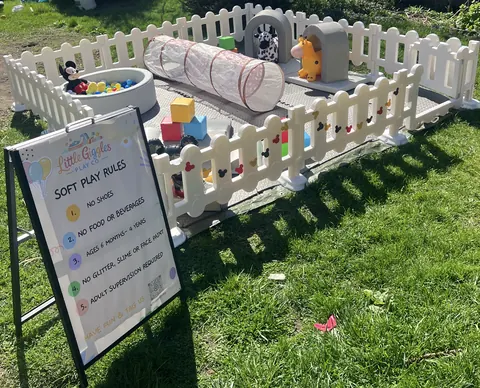 Outdoor soft play area with a soft play rules sign